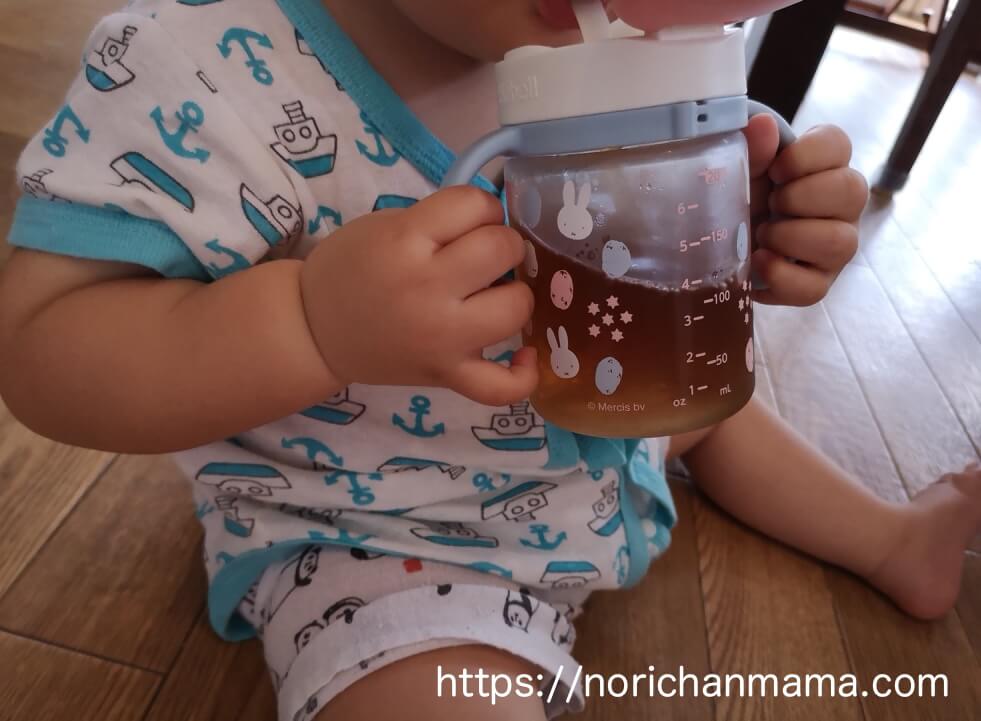 Baby drinking with straw mug